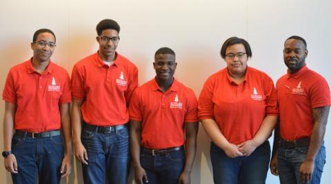 Five Howard students in red shirts.