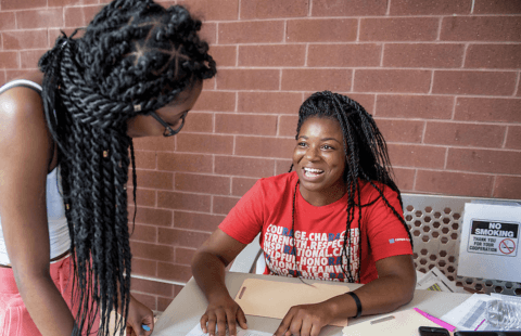 A resident assistant speaking with a student.