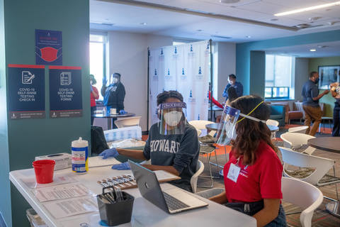 Students wearing PPE in a residential setting.