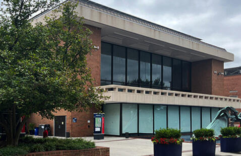 exterior image of Blackburn University Center building with foliage and decorative water fountain in foreground